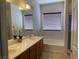 Bathroom featuring a tub, shower, dual vanity, and large window at 4036 Shetland Pony St, Las Vegas, NV 89122