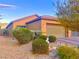 Charming single-story home featuring a well-manicured front yard and neutral color scheme at 4036 Shetland Pony St, Las Vegas, NV 89122