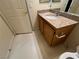 Bathroom with granite countertop vanity and wood cabinets at 10550 W Alexander Rd # 2149, Las Vegas, NV 89129