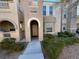 Tan two-story townhome with arched entryway and landscaping at 10550 W Alexander Rd # 2149, Las Vegas, NV 89129