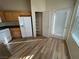 Kitchen with wood cabinets, white appliances, and pantry at 10550 W Alexander Rd # 2149, Las Vegas, NV 89129