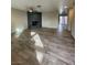 Spacious living room featuring a brick fireplace and wood-look tile floors at 2529 Rialto Rd, Las Vegas, NV 89108