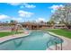 Sparkling backyard swimming pool with slide and well-manicured lawn under a sunny sky at 3690 S Rosecrest Cir, Las Vegas, NV 89121