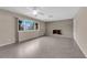 Bright living room with a brick fireplace, large window, ceiling fan, and neutral colors, creating a welcoming atmosphere at 3690 S Rosecrest Cir, Las Vegas, NV 89121