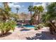 Spacious backyard oasis with a refreshing pool and palm trees at 440 Probst, Las Vegas, NV 89110