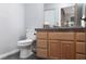 Clean bathroom with wood cabinets and a toilet at 440 Probst, Las Vegas, NV 89110