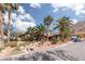 House with rock landscaping, palm trees, and a mountain view at 440 Probst, Las Vegas, NV 89110