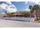 House with a white wall, wrought iron fence, and palm trees at 440 Probst, Las Vegas, NV 89110