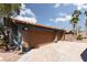 Three-car garage with tan doors and desert landscaping at 440 Probst, Las Vegas, NV 89110