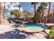 Inviting pool with rock waterfall and abundant palm trees at 440 Probst, Las Vegas, NV 89110