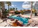 Stunning pool with rock landscaping and palm trees at 440 Probst, Las Vegas, NV 89110