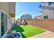 Artificial turf backyard with patio furniture and sitting area at 5029 Bloodhound St, Las Vegas, NV 89122