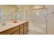 Bathroom with double vanity, large mirror, and walk-in shower at 5029 Bloodhound St, Las Vegas, NV 89122