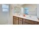 Bathroom with double vanity, large mirror, and shower/tub combo at 5029 Bloodhound St, Las Vegas, NV 89122