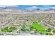 Panoramic aerial view showcases the community, its parks, and the majestic mountains beyond at 952 Contadero Pl, Las Vegas, NV 89138