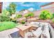 Landscaped backyard with lush greenery, a charming water feature, and an inviting outdoor seating area for relaxing at 952 Contadero Pl, Las Vegas, NV 89138