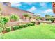 Serene backyard featuring lush greenery, palm trees, and a stone retaining wall with a charming water fountain feature at 952 Contadero Pl, Las Vegas, NV 89138