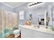 Clean, well-lit bathroom with a vanity, white cabinets, framed mirror and shower-tub combo with curtain at 952 Contadero Pl, Las Vegas, NV 89138