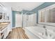 Bright bathroom featuring a soaking tub and a glass shower with a granite countertop sink at 952 Contadero Pl, Las Vegas, NV 89138