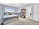 Serene bedroom with plush carpeting, a comfortable bed, large window, and built-in bookshelves at 952 Contadero Pl, Las Vegas, NV 89138