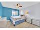 Bright bedroom with a ceiling fan, blue accent wall, carpeted floor, and well-lit windows at 952 Contadero Pl, Las Vegas, NV 89138