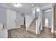 Inviting home entryway with wood laminate flooring, a staircase, and white trim at 952 Contadero Pl, Las Vegas, NV 89138