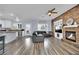 Open concept kitchen and living area with stone accents and hardwood floors at 952 Contadero Pl, Las Vegas, NV 89138