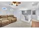 Comfortable living room featuring a reclining sofa and carpet flooring and bright natural light at 952 Contadero Pl, Las Vegas, NV 89138