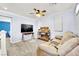 Cozy living room with a ceiling fan, plush seating, media console, and windows for natural light at 952 Contadero Pl, Las Vegas, NV 89138