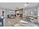 Open living area with stone fireplace, fan and modern wood-style flooring at 952 Contadero Pl, Las Vegas, NV 89138