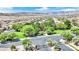 Aerial neighborhood shot with green trees, well maintained streets and houses, and desert mountain views at 952 Contadero Pl, Las Vegas, NV 89138