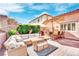 Outdoor patio with seating area, umbrella, and built-in grill at 952 Contadero Pl, Las Vegas, NV 89138