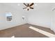 Sunny bedroom with plush carpet and ceiling fan at 12253 Bluebird Canyon Pl, Las Vegas, NV 89138