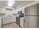Modern kitchen featuring stainless steel appliances and light wood laminate flooring at 2725 S Nellis Blvd # 2096, Las Vegas, NV 89121