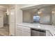 Kitchen with stainless steel dishwasher and view into living area at 2725 S Nellis Blvd # 2096, Las Vegas, NV 89121