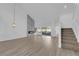 Bright and airy living room with hardwood floors and staircase at 6940 Emerald Springs Ln, Las Vegas, NV 89113