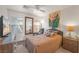 Comfortable bedroom with a ceiling fan, mirror, and a bird of paradise painting at 716 Solitude Point Ave, Henderson, NV 89012