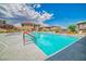 Community pool with clear blue water, surrounded by community buildings and ample lounge chairs at 716 Solitude Point Ave, Henderson, NV 89012