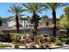 Scenic community entrance with lush landscaping, mature palm trees, and attractive signage at 716 Solitude Point Ave, Henderson, NV 89012