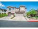 Inviting two-story townhome showcasing a double garage, landscaped front yard, and charming curb appeal at 716 Solitude Point Ave, Henderson, NV 89012