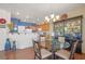 Bright kitchen area with glass dining table and chairs adjacent to the wooden cabinets at 716 Solitude Point Ave, Henderson, NV 89012