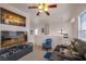 Upstairs living area features a reclining sofa, chair, and entertainment center at 716 Solitude Point Ave, Henderson, NV 89012