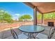 Charming covered patio with wrought iron furniture, perfect for relaxing and enjoying the outdoor view at 716 Solitude Point Ave, Henderson, NV 89012