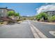 Picturesque street view of a quiet neighborhood with lush trees and well-kept homes at 716 Solitude Point Ave, Henderson, NV 89012