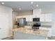 Bright kitchen featuring white cabinets, granite countertops, and stainless steel appliances at 8279 Palladium St, Las Vegas, NV 89113