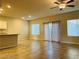 Open-concept living room with a ceiling fan and sliding glass doors to the backyard at 8279 Palladium St, Las Vegas, NV 89113