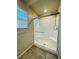 Tiled shower stall featuring glass doors and bench seating at 8279 Palladium St, Las Vegas, NV 89113