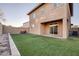 Artificial turf backyard with covered patio and block wall at 356 Espressivo St, Henderson, NV 89011