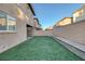 Artificial turf backyard with block wall and home at 356 Espressivo St, Henderson, NV 89011