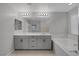 Double vanity bathroom with soaking tub and large mirror at 356 Espressivo St, Henderson, NV 89011